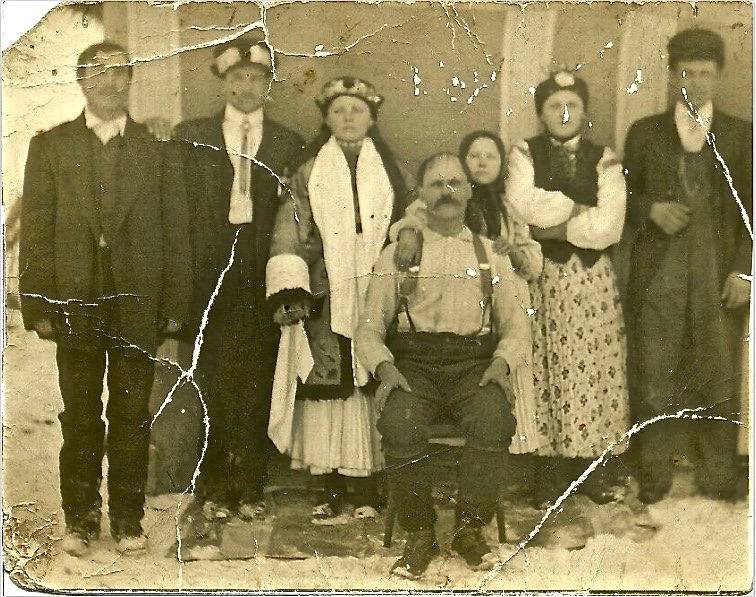 An installation with paintings, textiles and ladders is shown as a physical collage. The space they sit within is white and lit from above.