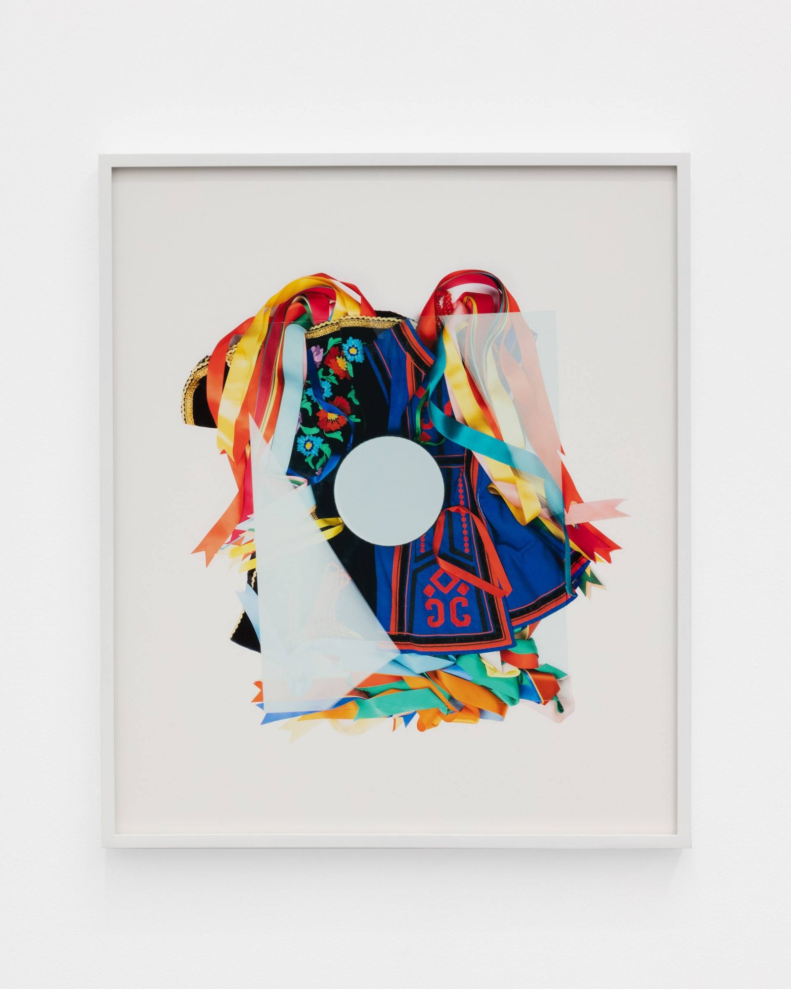 A Carpathian region Ukrainian dance costume is compressed beneath a sheet of glass.